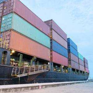 Back view of Red Container truck in ship port Logistics.Transportation industry in port business concept.import,export logistic industrial Transporting Land transport on Port transportation storge
